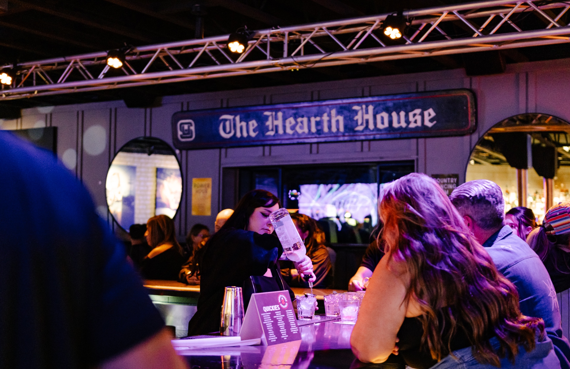 Bartender pouring drinks at Hearth House bar